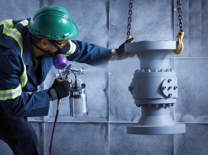 DNOW paint expert is applying a high-performance coating to a valve DNOW paint expert is applying a high-performance coating to a valve