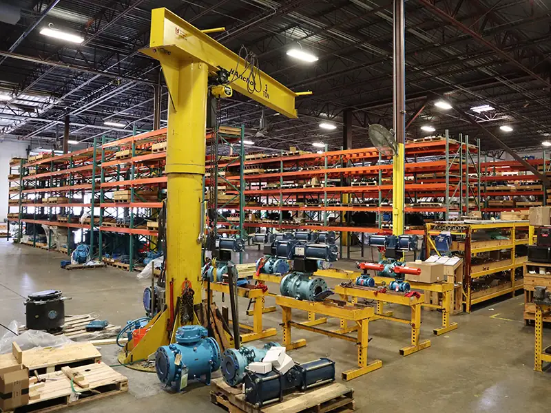 Valve actuation workshop at Whitco Supply with a variety actuated valves on workbenches and a large lifting crane Valve actuation workshop at Whitco Supply with a variety actuated valves on workbenches and a large lifting crane